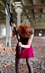 Redhead with a guitar using it like an axe.