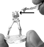 Attaching the first arm: the proper position to hold the figure